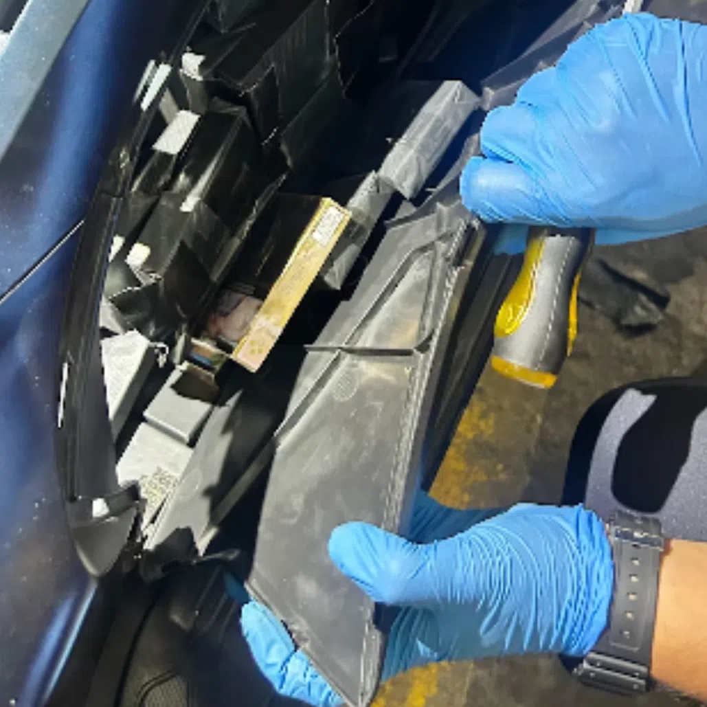 More than 400 packets of duty-unpaid cigarettes were found and removed from the side fairings of a motorcycle.