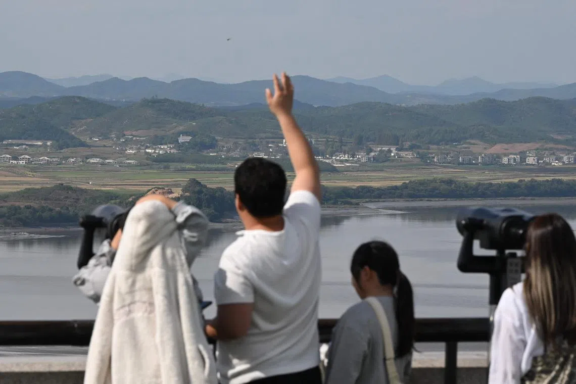 Visitors use binoculars to look at the North Korean side of the Demilitarised Zone dividing the two Koreas, from South Korea's Odusan Unification Observatory in Paju on Oct 9.