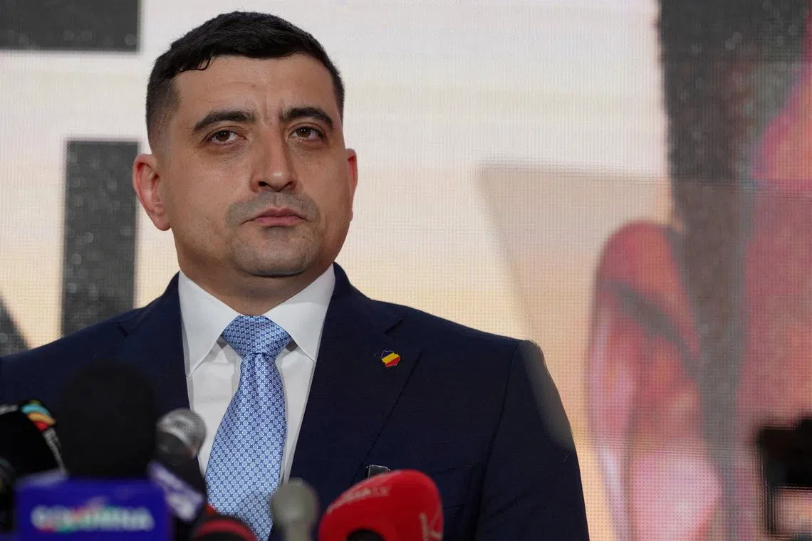 FILE PHOTO: George Simion, leader of the opposition Alliance for Uniting Romanians (AUR), talks to media after submitting his candidacy for a repeat presidential election, in Bucharest, Romania, March 14, 2025. REUTERS/Andreea Campeanu/File Photo