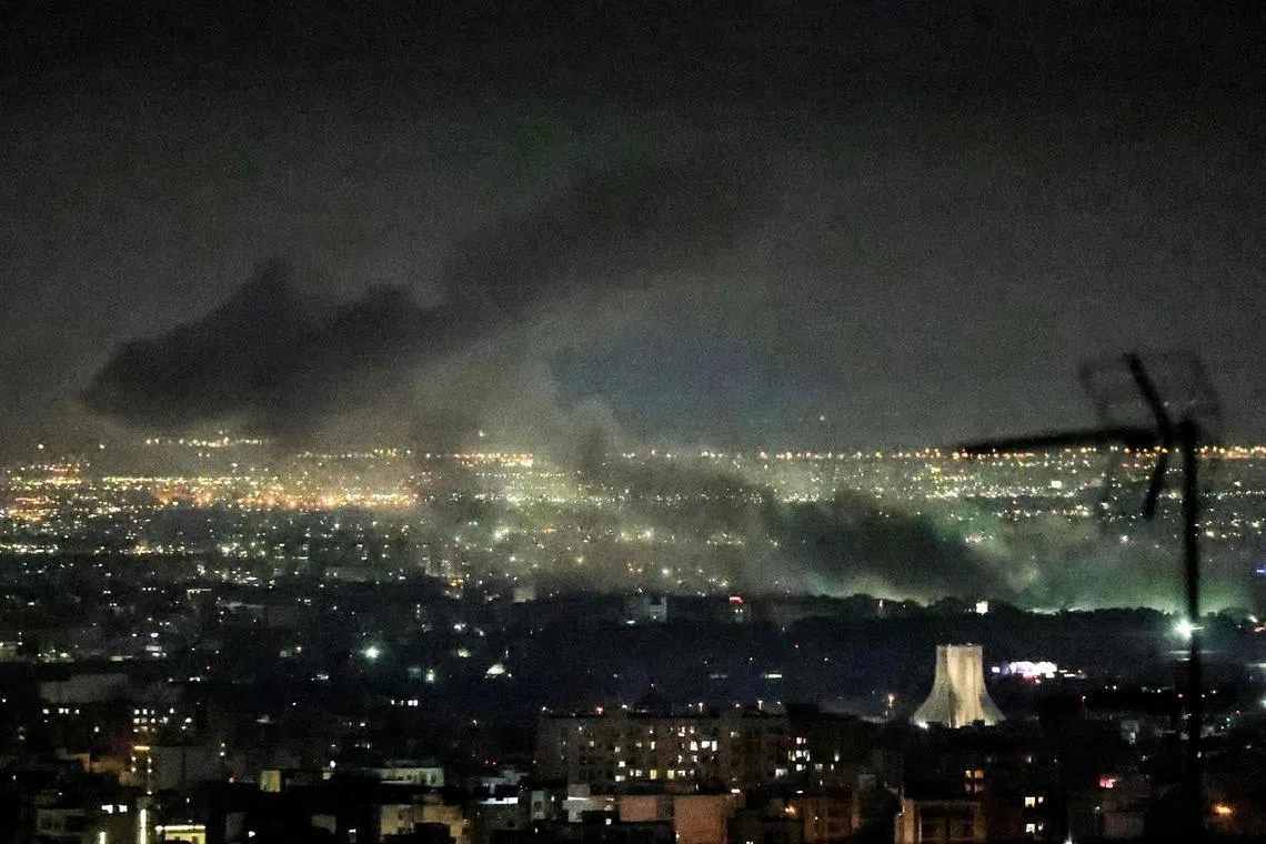 Smoke rising from the site of air strikes in western Tehran on March 10.