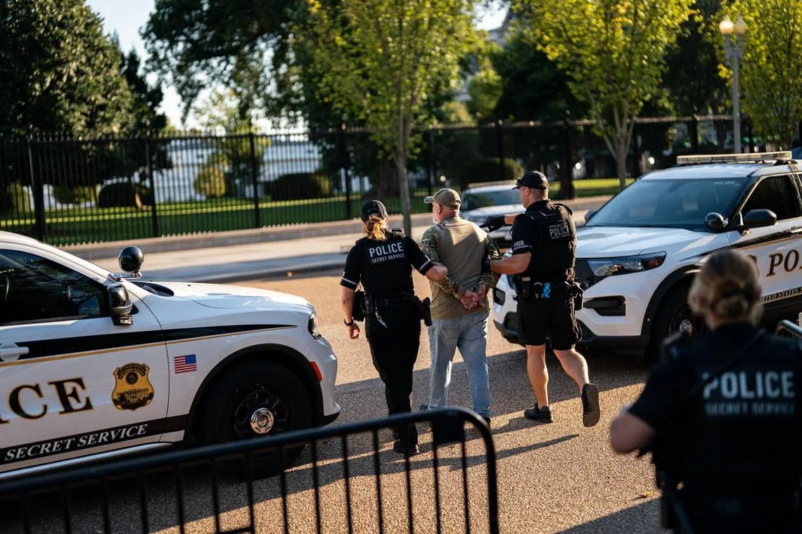 US Secret Service agents detaining an individual for lighting an American flag on fire in Lafayette Park, outside the White House, on Aug 25.