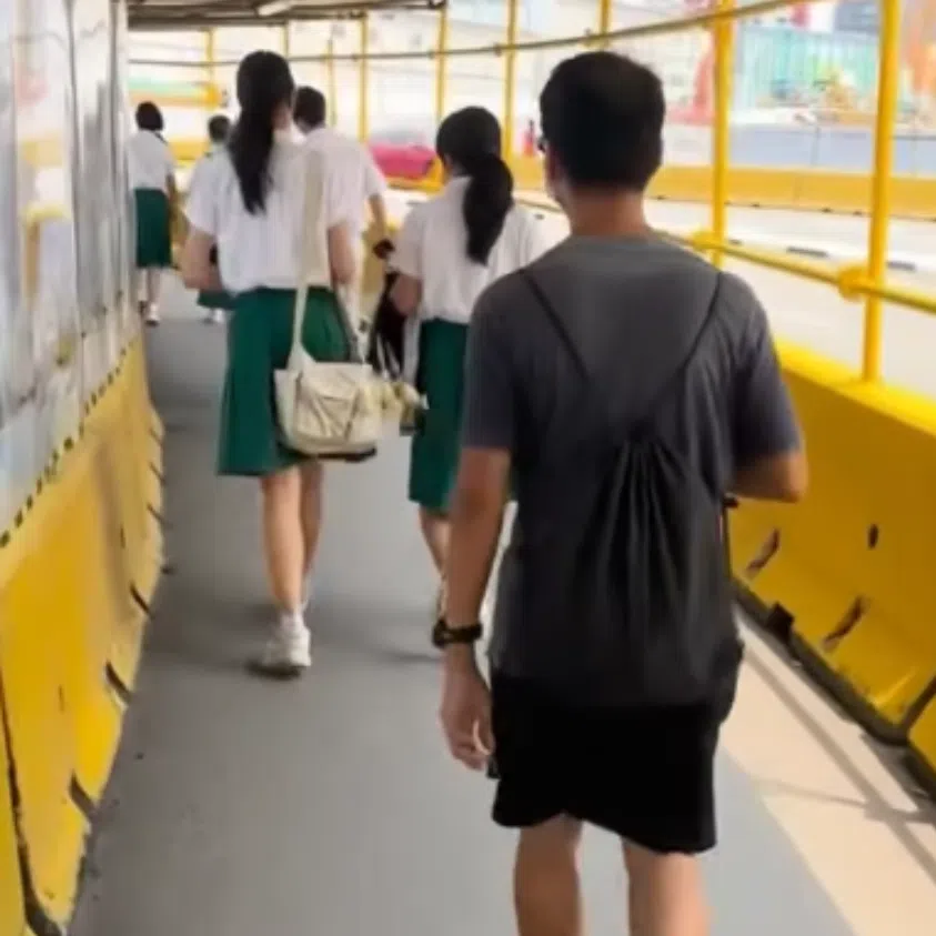 A video of the incident circulating online shows a bespectacled man walking behind a pair of female students in uniform resembling that of Raffles Institution.