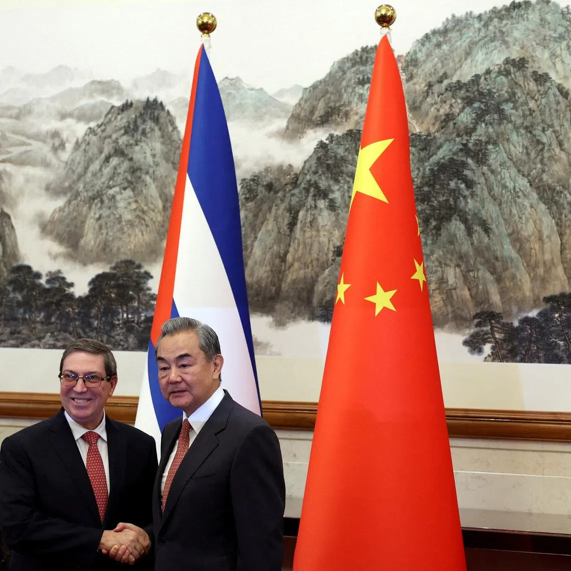 FILE PHOTO: Chinese Foreign Minister Wang Yi and Cuban Foreign Minister Bruno Rodriguez Parrilla shake hands before their meeting at the Diaoyutai State Guesthouse in Beijing, China May 12, 2025. REUTERS/Florence Lo/Pool/File Photo