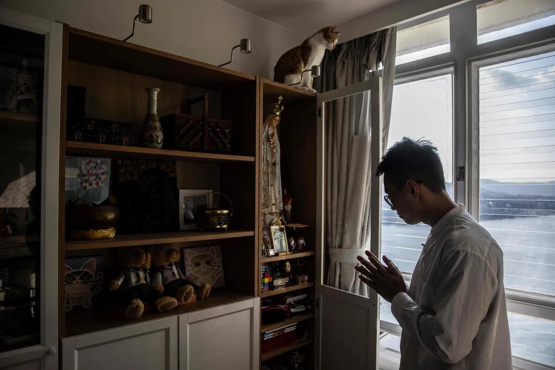 Mr Henry Li looking at a photo of himself and his husband Edgar Ng, who died by suicide in 2020.
