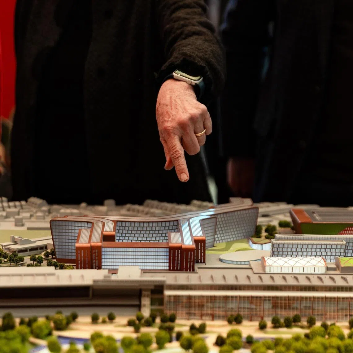 A member of The New York Gaming Facility Location Board points to a model of a casino during a visit to the Resorts World electronic gambling emporium in Queens on Nov 17.