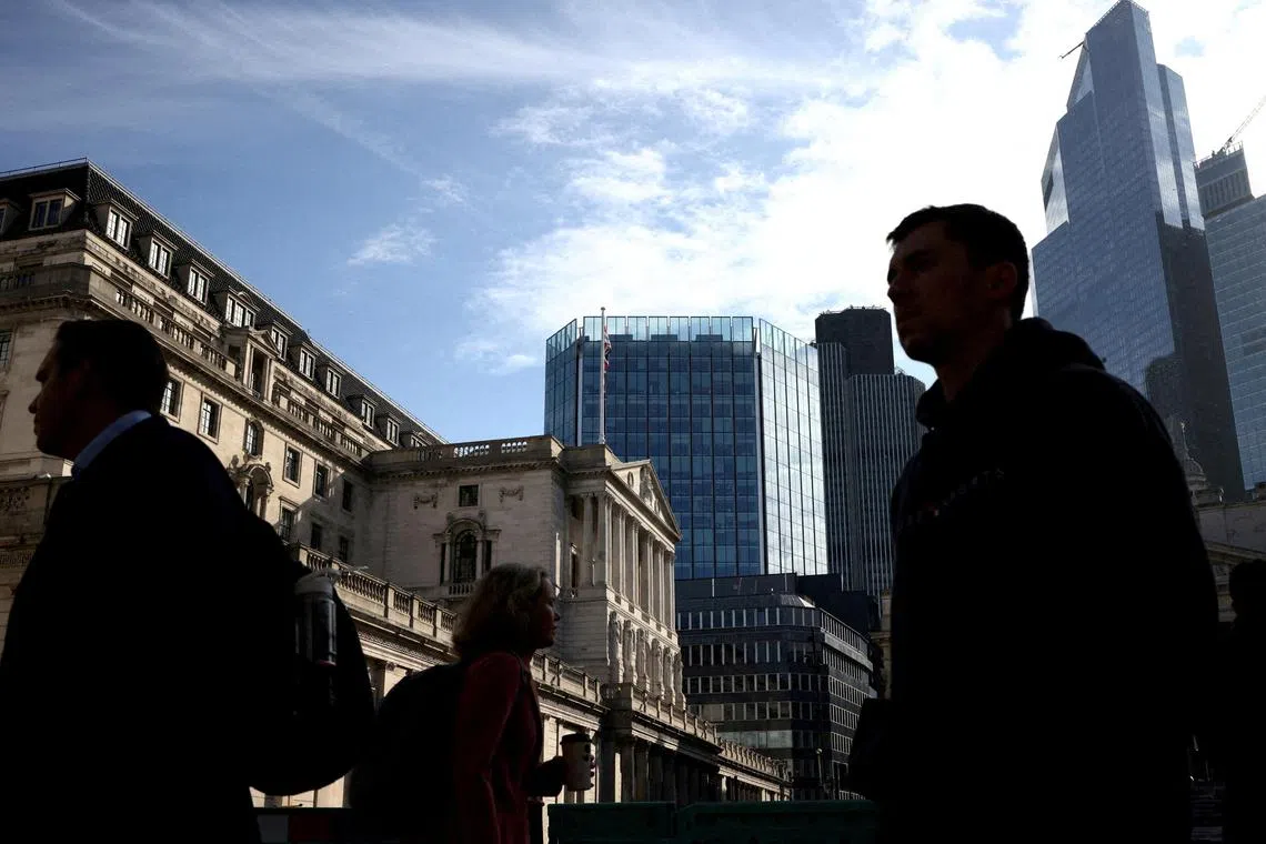 FILE PHOTO: People walk in the financial district in London, Britain May 11, 2023. REUTERS/Henry Nicholls/File Photo