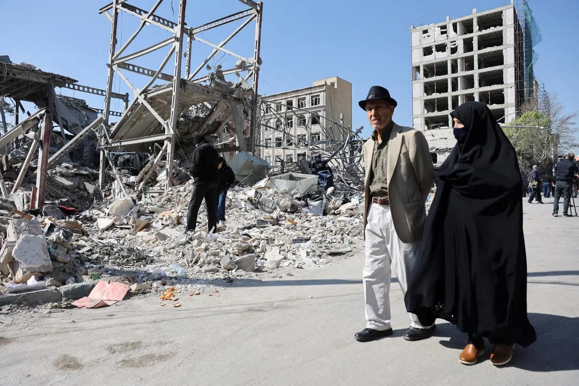 People walk past debris in the aftermath of a strike on a police station, amid the U.S.-Israeli conflict with Iran, in Tehran, Iran, March 4, 2026. Majid Asgaripour/WANA (West Asia News Agency) via REUTERS