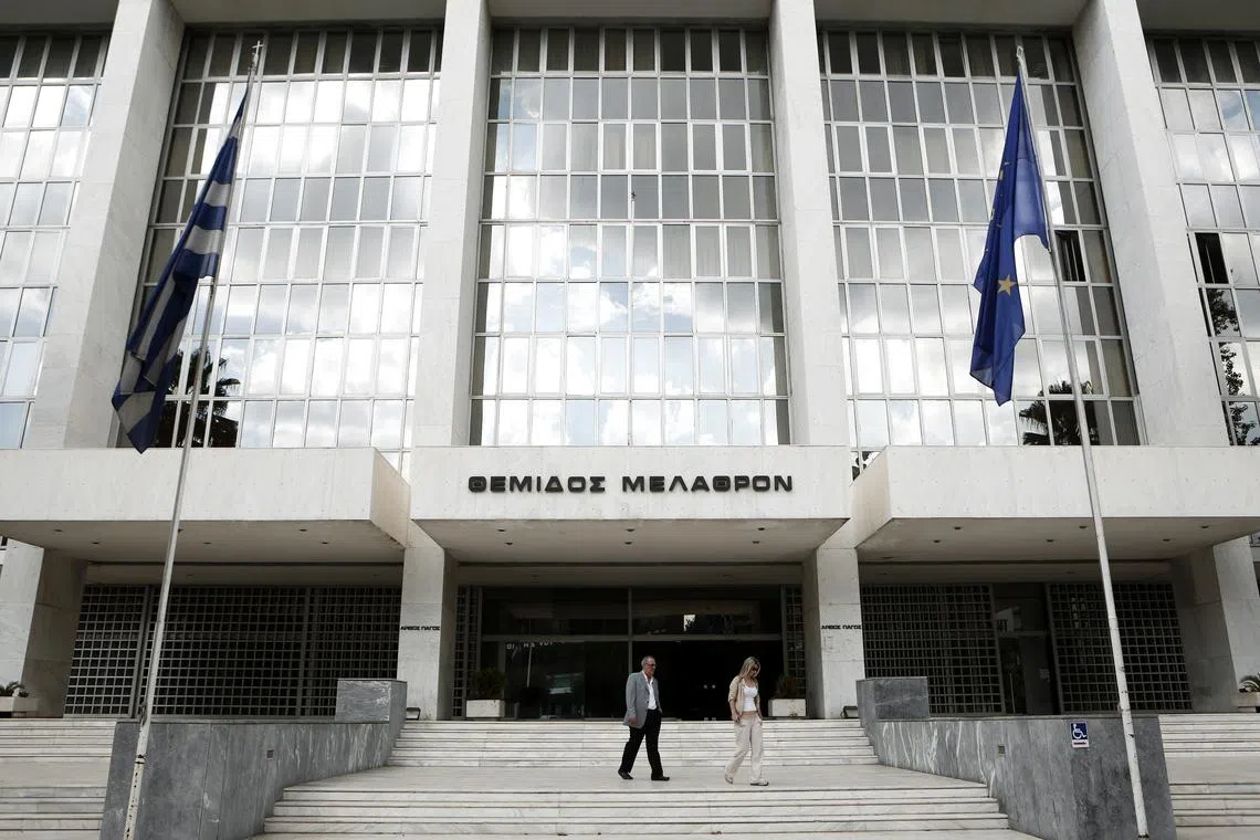 FILE PHOTO: People walk outside Greece's Supreme Court in Athens September 17, 2012. REUTERS/Yorgos Karahalis/ File photo