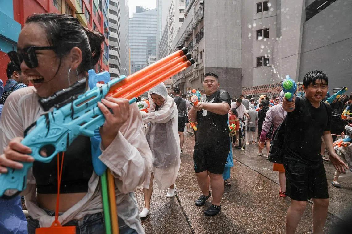 Revellers use water guns in a water fight during Songkran Festival celebrations, in Hong Kong.