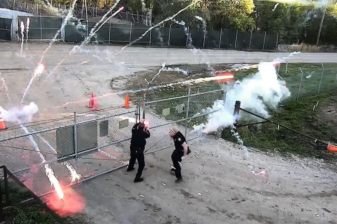 Security videos show people throwing rocks and explosive devices toward police who were struggling to lock the gate.