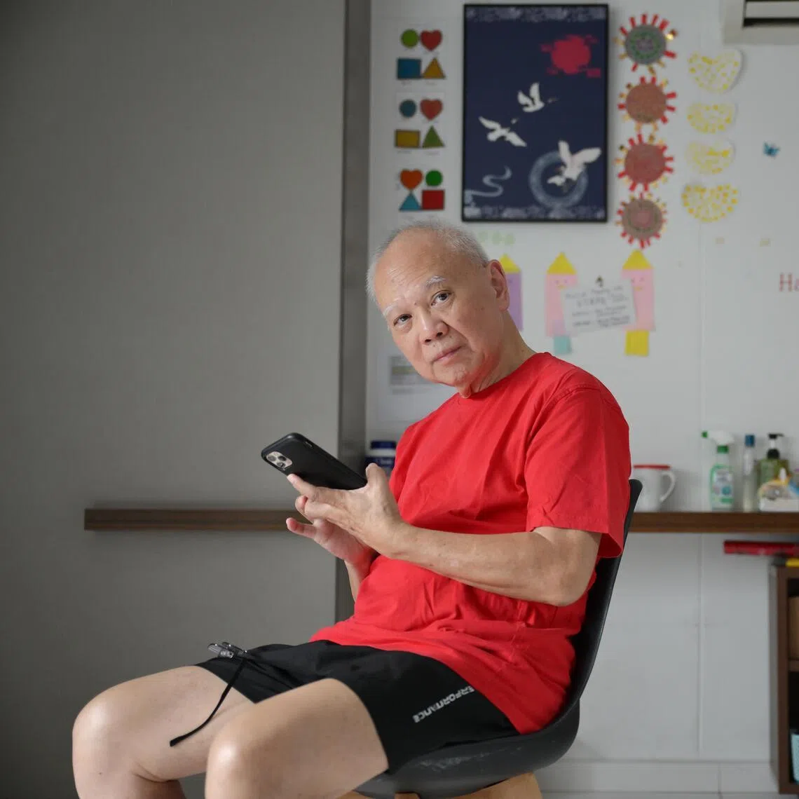 Mr Ho Khee Tong, 75, spends hours daily on his smartphone scrolling, watching videos or playing games.