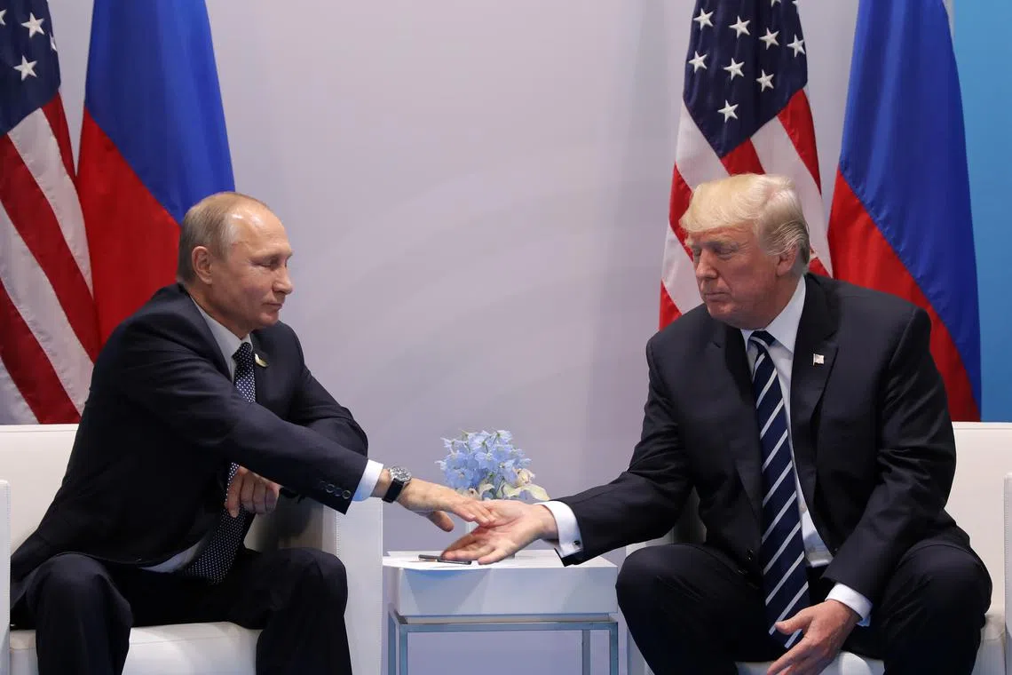 FILE PHOTO: U.S. President Donald Trump shakes hands with Russian President Vladimir Putin during the their bilateral meeting at the G20 summit in Hamburg, Germany July 7, 2017. REUTERS/Carlos Barria/File Photo
