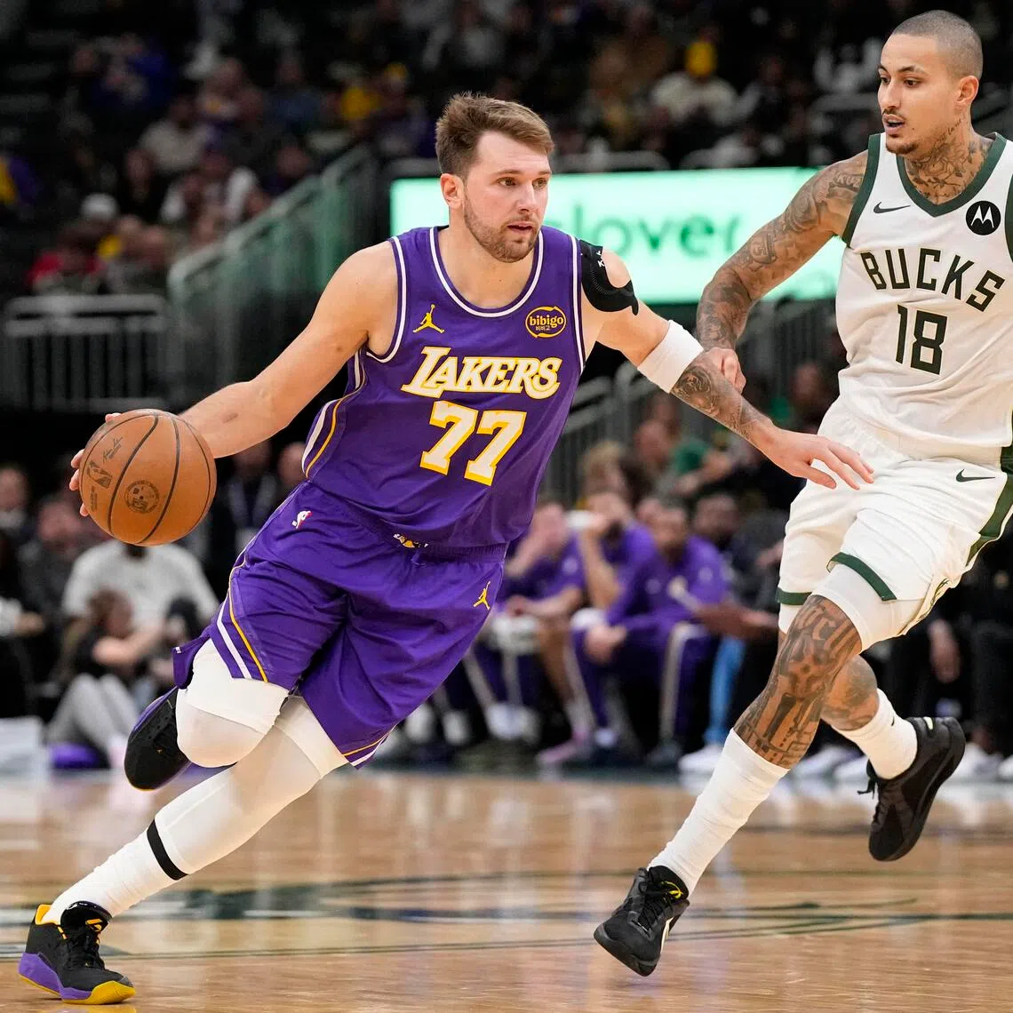 Los Angeles Lakers guard Luka Doncic drives towards the basket around Milwaukee Bucks forward Kyle Kuzma during the third quarter at Fiserv Forum. 