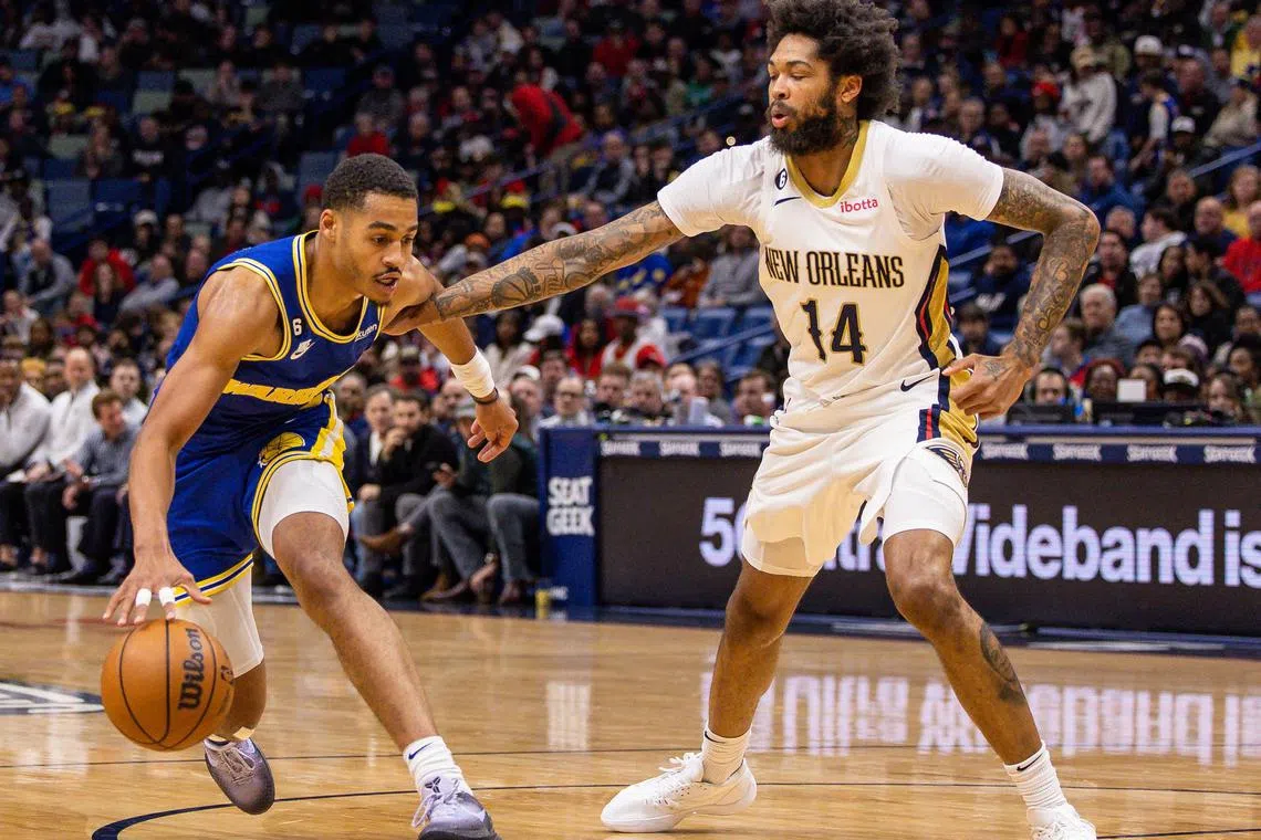 Golden State Warriors guard Jordan Poole is fouled by New Orleans Pelicans forward Brandon Ingram during the first half at Smoothie King Centre.