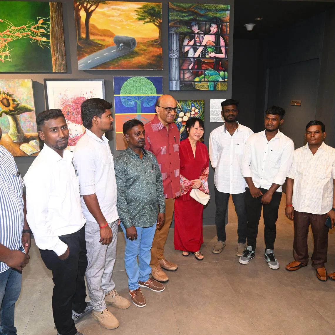 President Tharman Shanmugaratnam and wife Ms Jane Ittogi (centre) taking a group photo with the construction workers involved in the Tanjong Katong sinkhole rescue at the National Day Istana Open House on Aug 3.