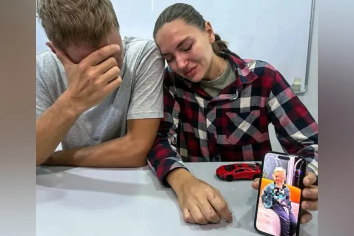 Mr Nikita Iakubanets (left) and his wife Olga holding up a photo of their son Vladimir, who died from complications after being stung by a box jellyfish in Langkawi.