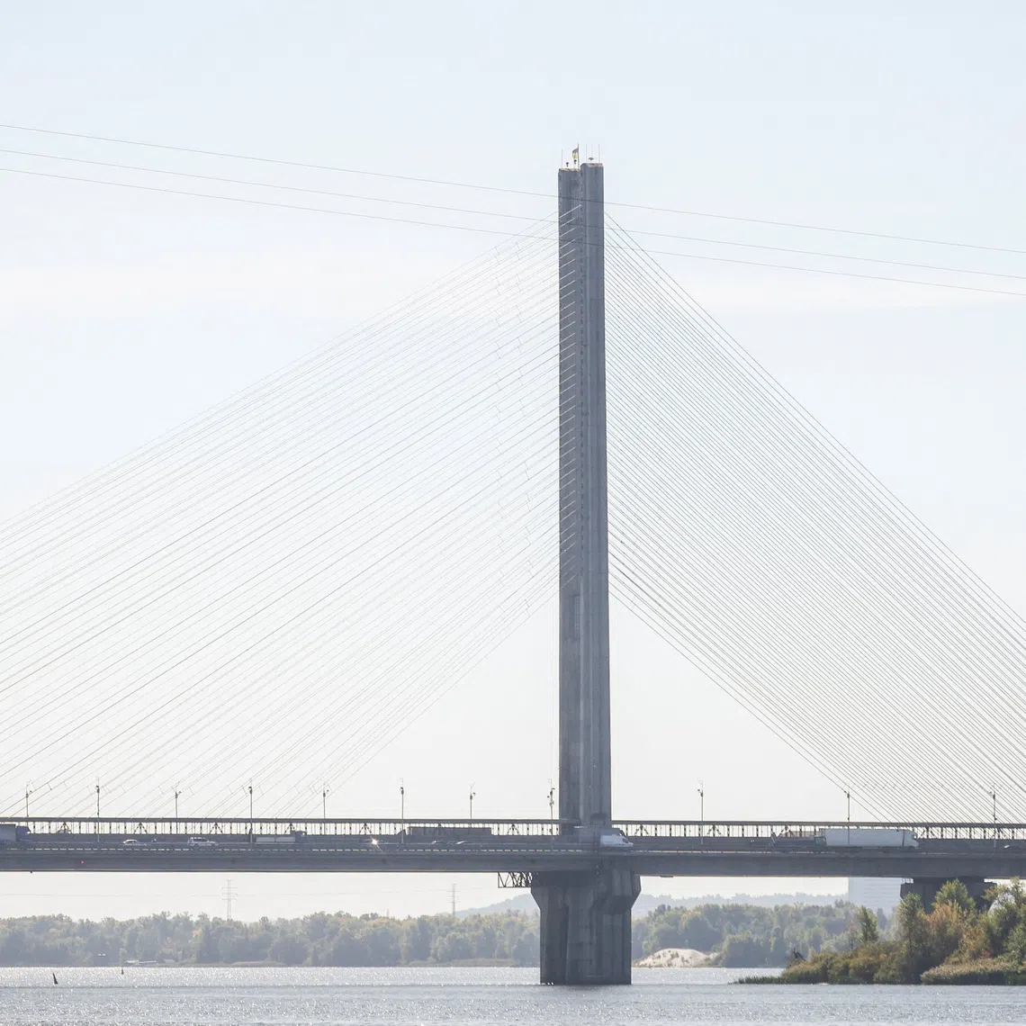 Cars drive across a bridge over the Dnipro River after it was hit during a Russian jet drone strike, amid Russia's attack on Ukraine, in Kyiv, Ukraine, October 1, 2026. REUTERS/Alina Smutko