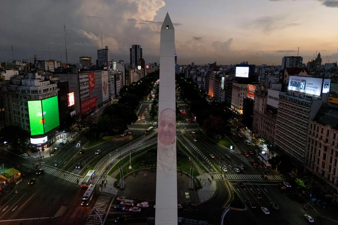 A drone view shows an image of Pope Francis displayed with a digital video-mapping at the Obelisco as the worlds pray for the pontiff's health, in Buenos Aires, Argentina, February 21, 2025. REUTERS/Martin Cossarini