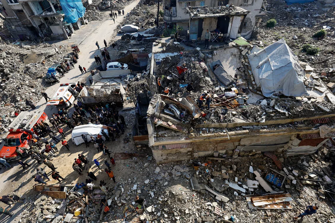People gather during a search and rescue operation at the site of a house that was partially destroyed during the war and collapsed on Tuesday, at Shati refugee camp in Gaza City, December 16, 2025. REUTERS/Mahmoud Issa