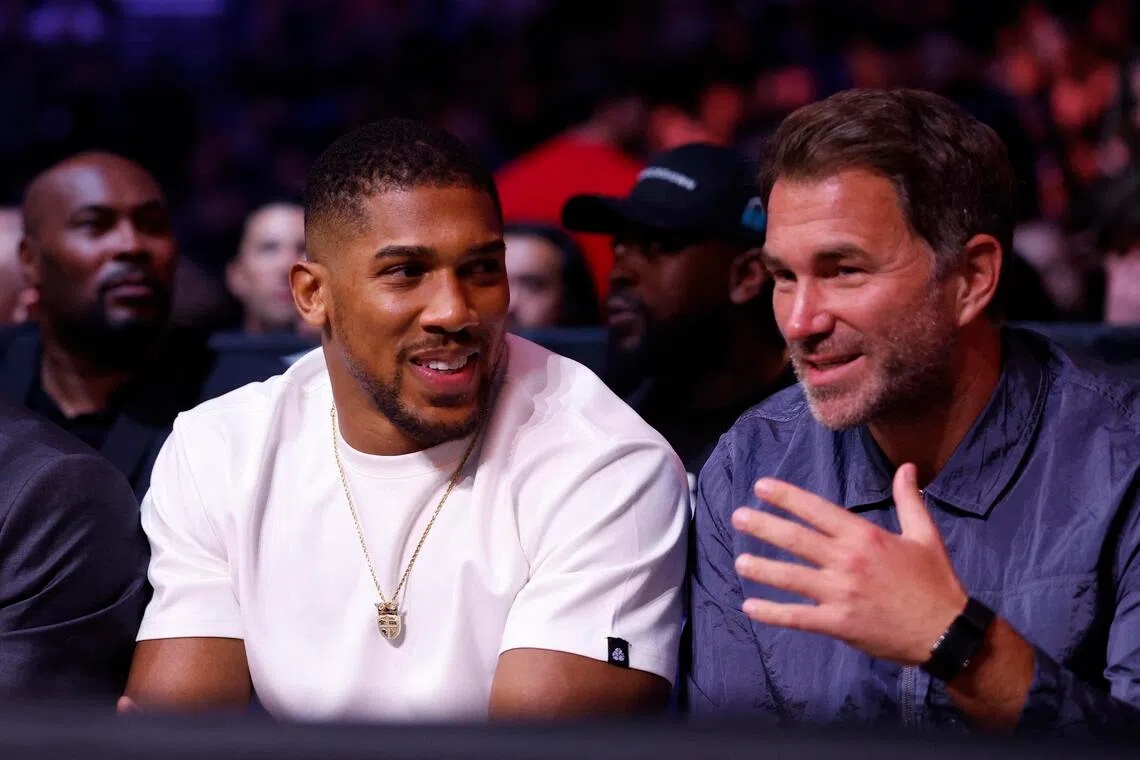 Former boxing champion Anthony Joshua (left) is seen with promoter Eddie Hearn ahead of the Derek Chisora-Deontay Wilder fight at London’s 02 Arena on April 4, 2026.