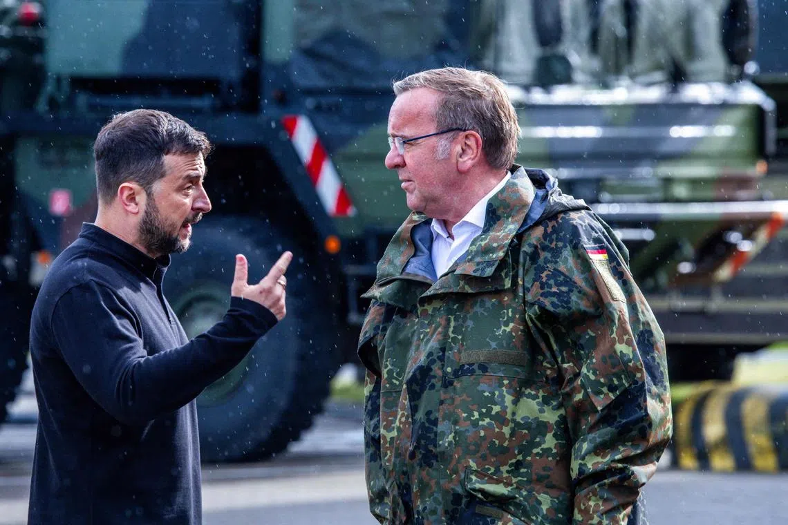 Ukrainian President Volodymyr Zelensky (left) being hosted by German Defence Minister Boris Pistorius, at a military training area in north-eastern Germany, on June 11.