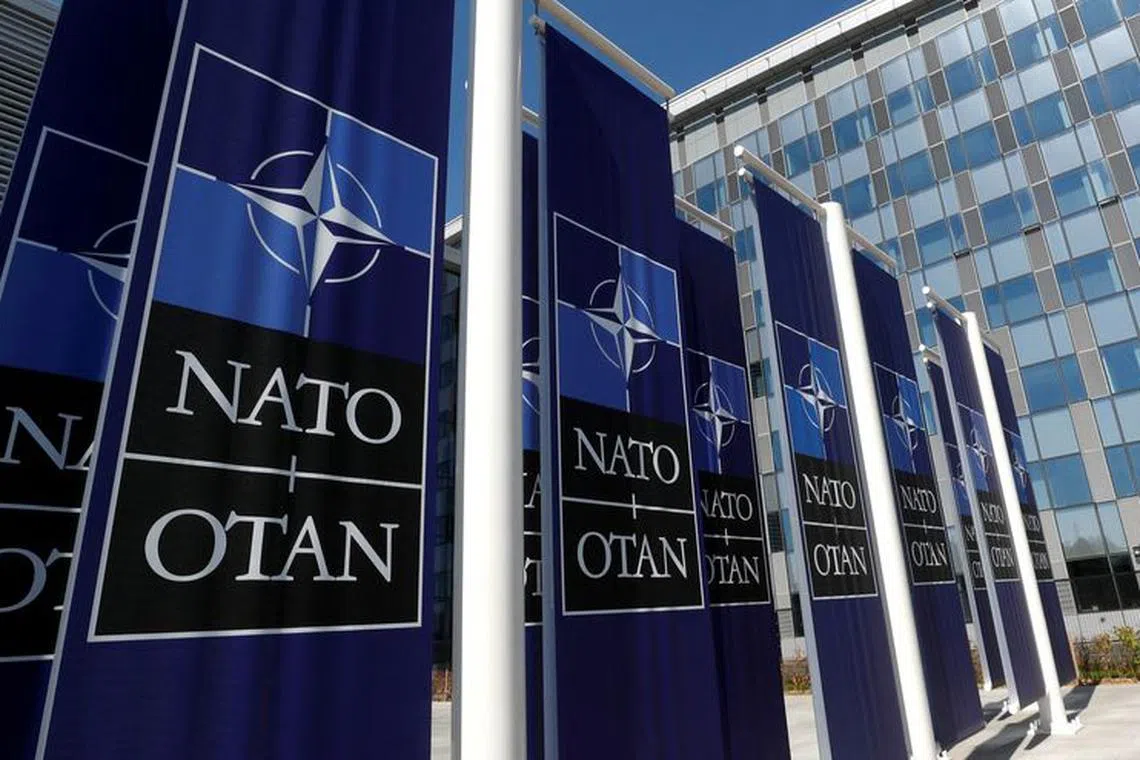 FILE PHOTO: Banners displaying the NATO logo are placed at the entrance of new NATO headquarters during the move to the new building, in Brussels, Belgium April 19, 2018.  REUTERS/Yves Herman/File Photo