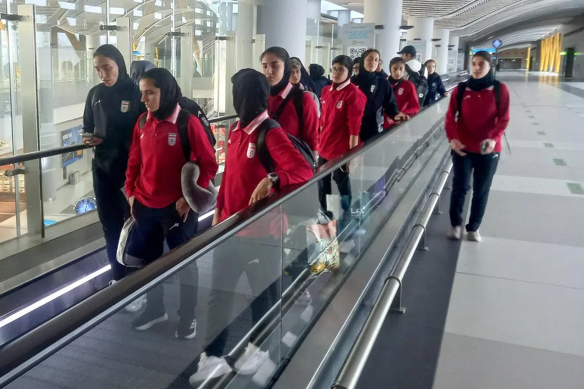 Members of the Iranian women's national soccer team walk at the international arrival terminal of the Istanbul Airport in Istanbul, Turkey, March 17, 2026.  REUTERS/Stringer