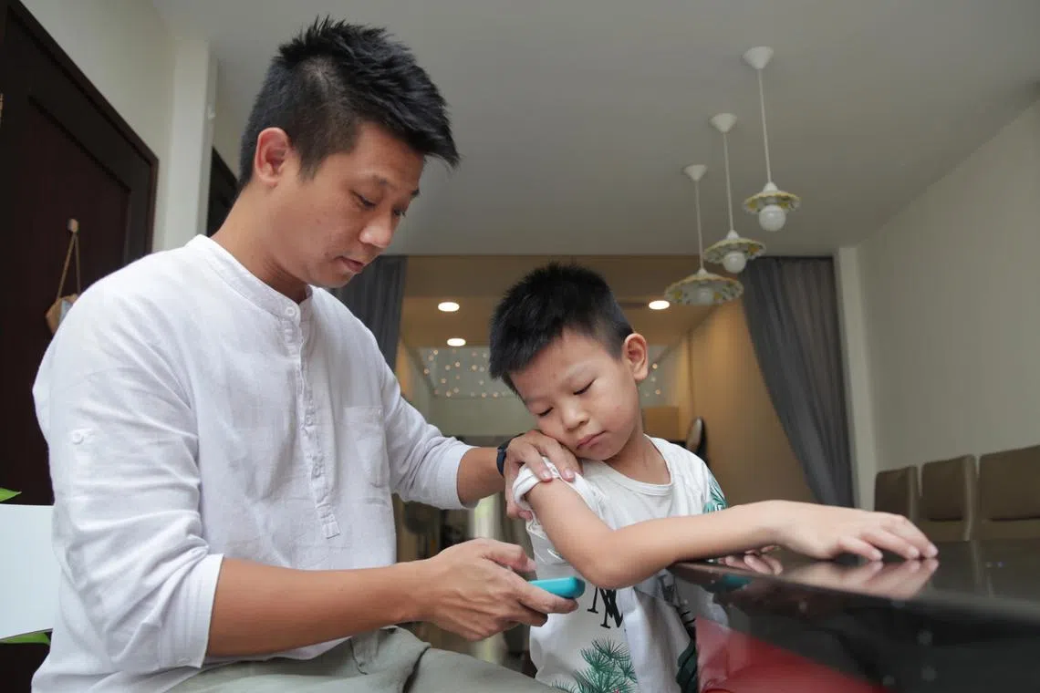 Seven-year-old Joshua Wong, seen here with his father  Wong Soon Yeow, was diagnosed with Type 1 diabetes in 2019.