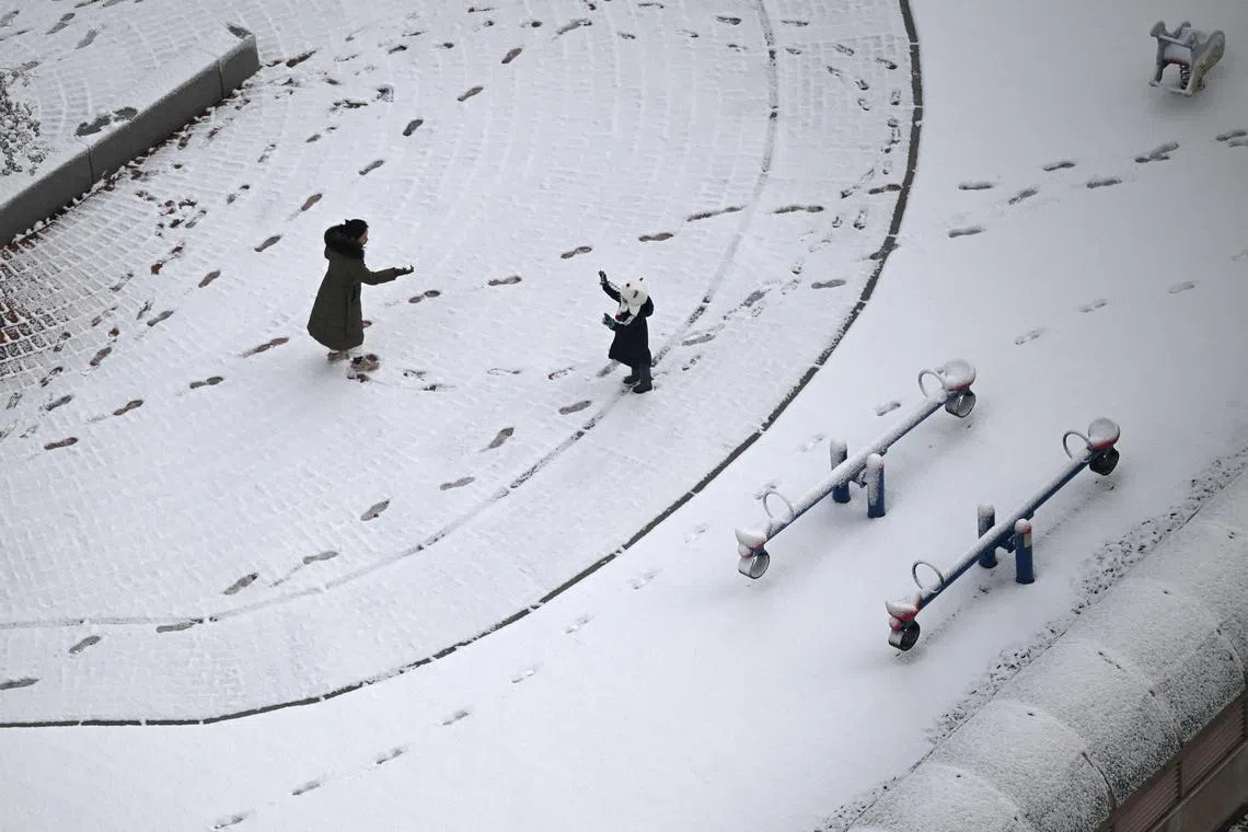A mother and child playing in a snow-covered playground in Goyang on Nov 27, 2024. 