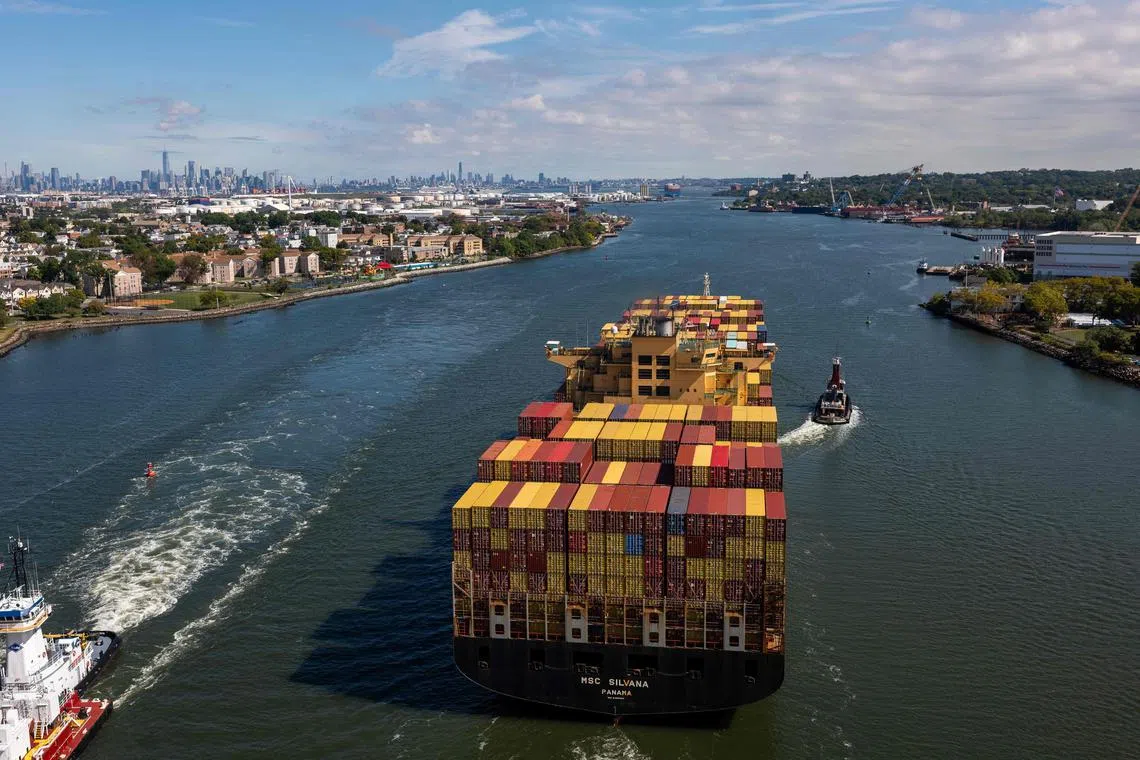 A container ship departs the Port of Newark for the Atlantic Ocean on Sept 30, seen from New York City. 