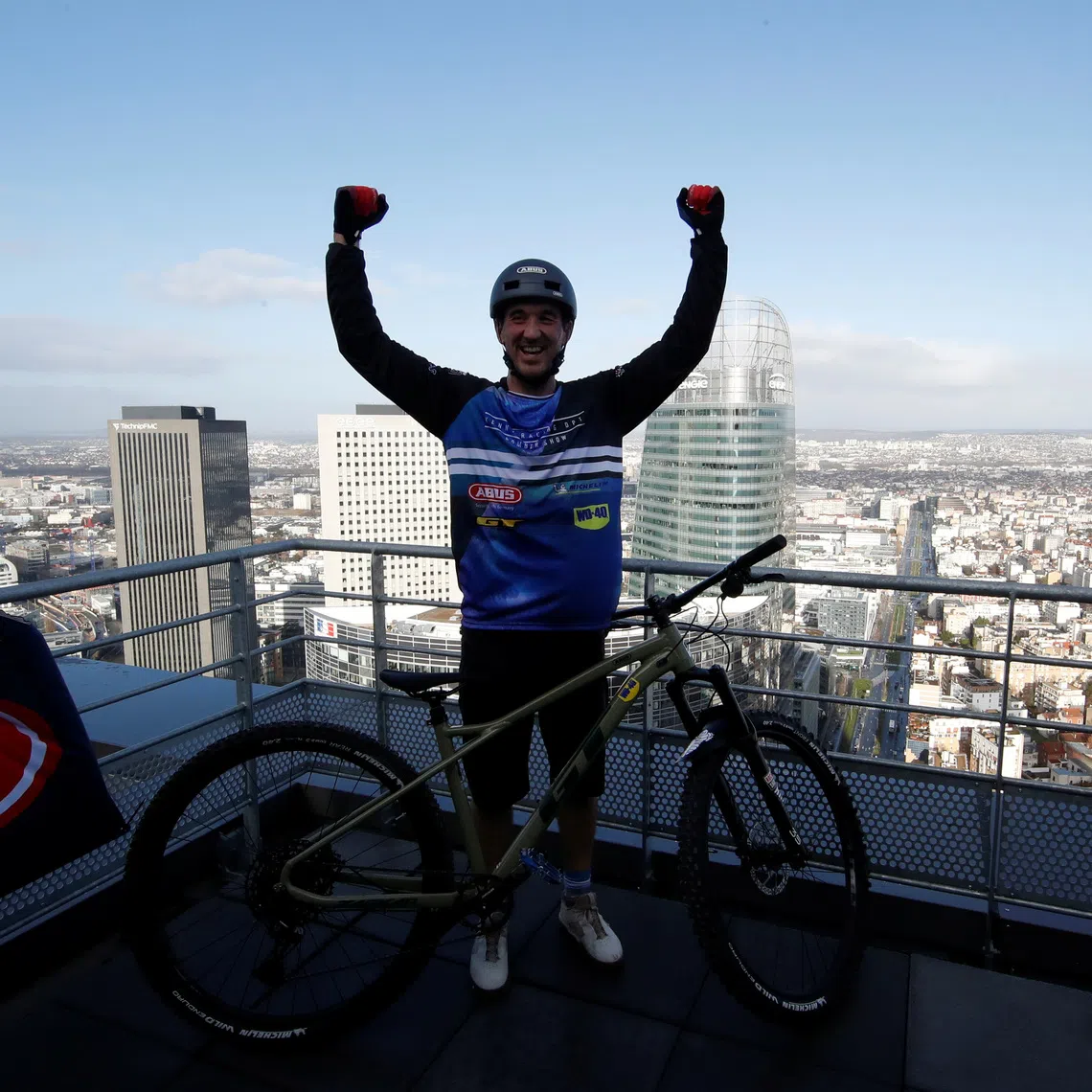 French professional mountain biker Aurelien Fontenoy reacts after climbing the 768 steps, 33 flors and 140 metres high Trinity Tower in the financial and business district of La Defense near Paris, France, January 17, 2021. REUTERS/Gonzalo Fuentes