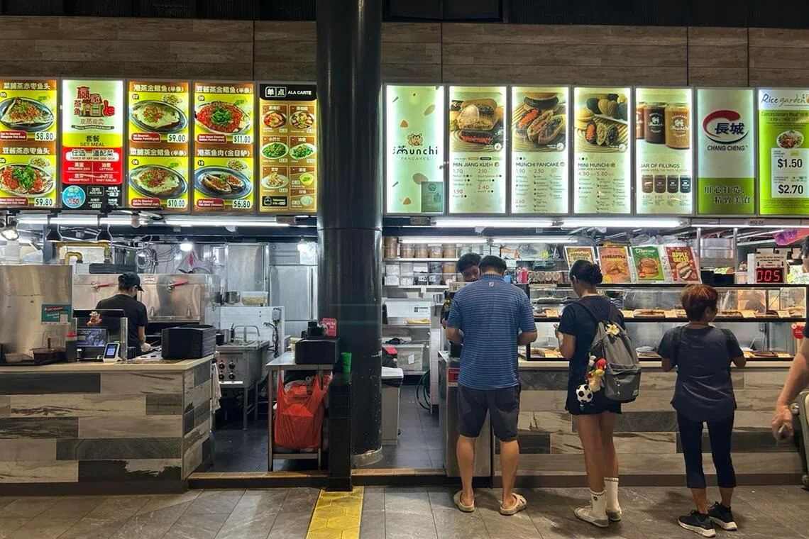 Stalls and patrons at Senja Hawker Centre.