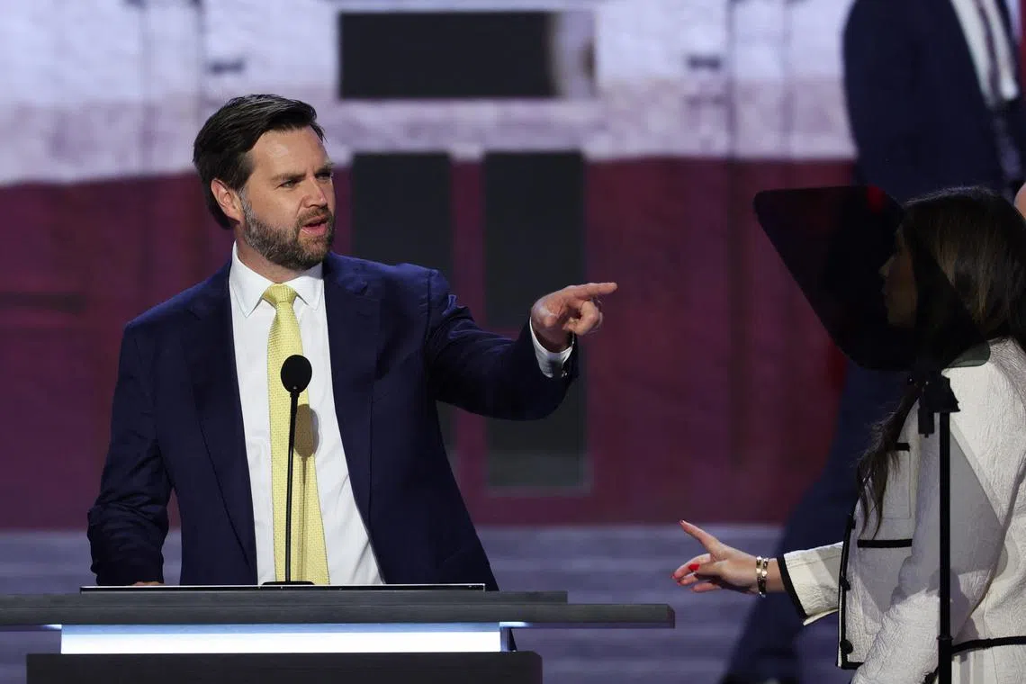 Republican vice presidential nominee J.D. Vance gestures on the stage ahead of Day 2 of the Republican National Convention (RNC), at the Fiserv Forum in Milwaukee, Wisconsin, U.S., July 16, 2024. REUTERS/Mike Segar