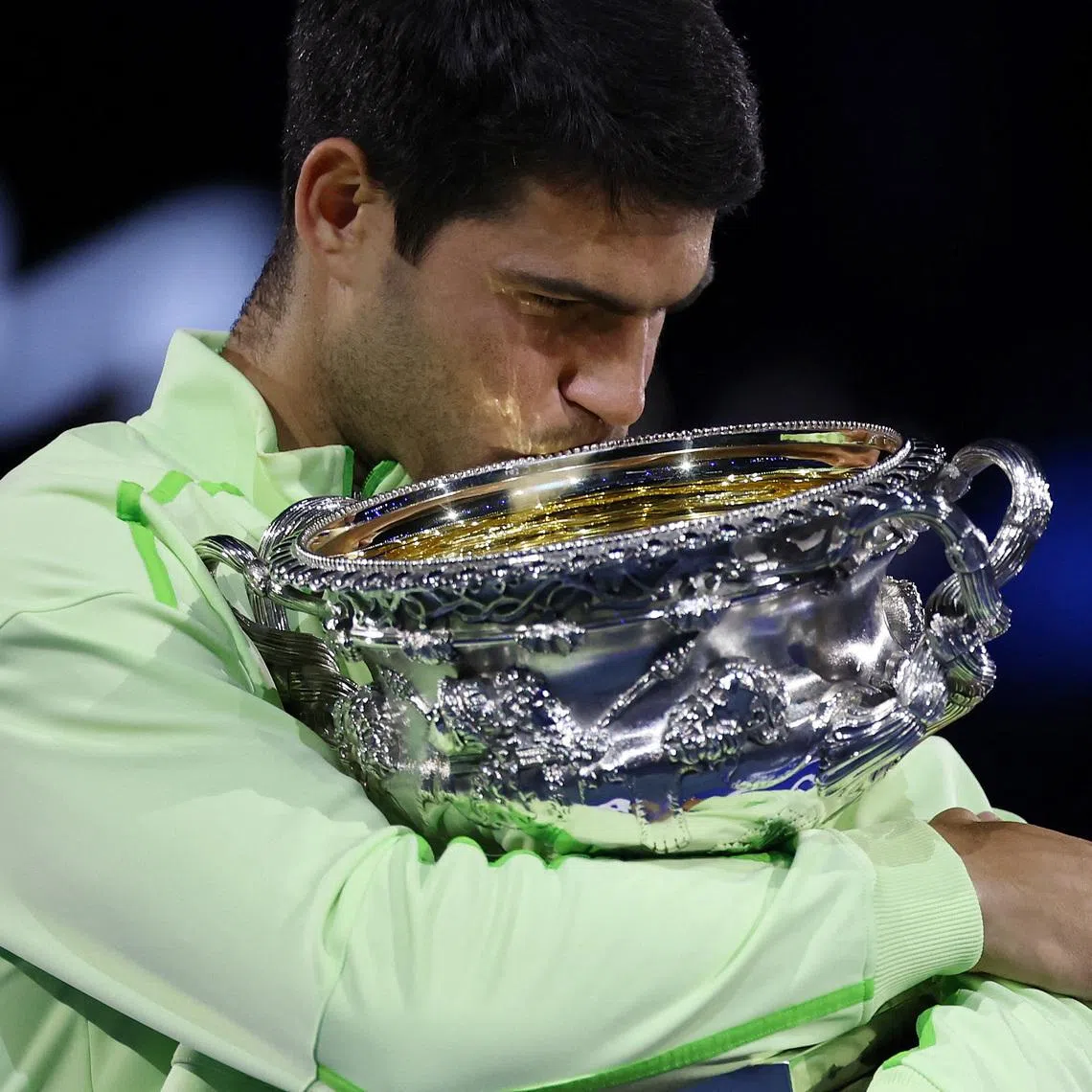 Carlos Alcaraz celebrating with the trophy after winning the Australian Open men's singles against Serbia's Novak Djokovic at Melbourne Park on Feb 1, 2026. Alcaraz becomes the youngest man to win all four Grand Slam titles.