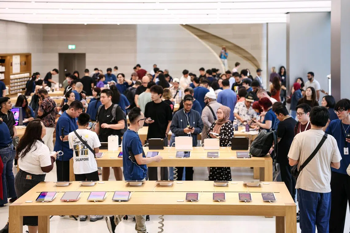 Customers shopping at the Apple Store on Sept 18.