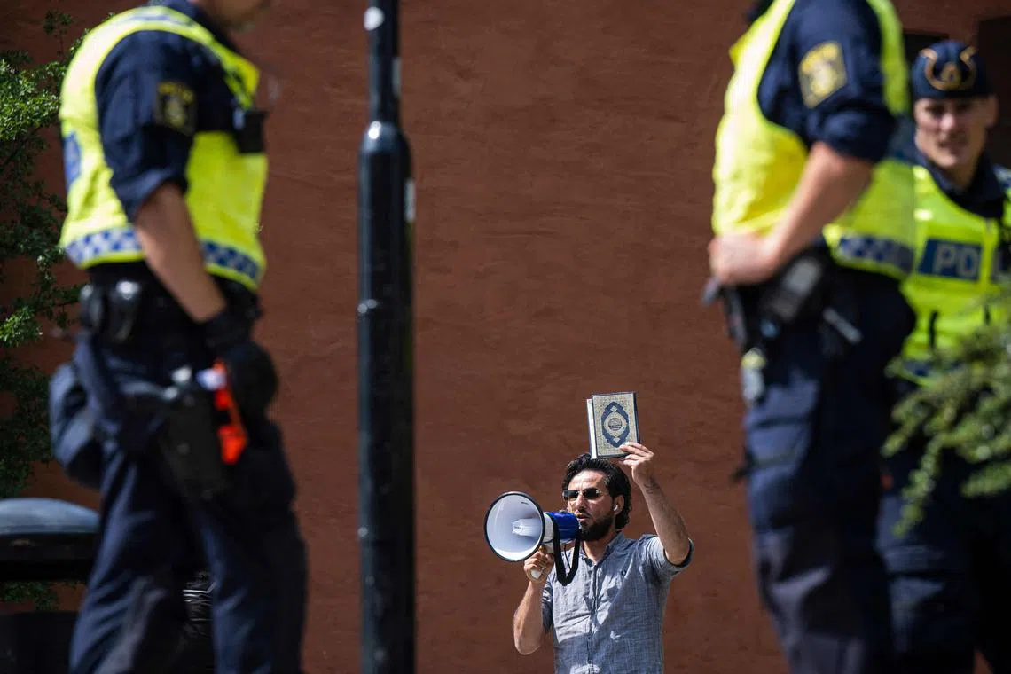 (FILES) Salwan Momika protests outside a mosque in Stockholm on June 28, 2023, during the Eid al-Adha holiday. Momika, who repeatedly burnt the Koran in 2023 in Sweden, sparking outrage in Muslim countries, has been shot dead, media reported on January 30, 2025, with police confirming a man died in a shooting the day before. A Stockholm court was due to rule on January 30, 2025 whether Salwan Momika, a Christian Iraqi who burned Korans at a slew of protests, was guilty of inciting ethnic hatred. It postponed the ruling, saying "one of the defendents has died." (Photo by Jonathan NACKSTRAND / AFP)