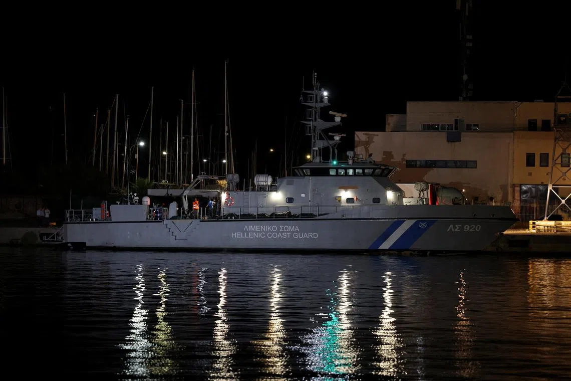 FILE PHOTO: Body bags carrying migrants who died after their boat capsized in the open sea off Greece, are seen onboard a Hellenic Coast Guard vessel at the port of Kalamata, Greece, June 14, 2023. REUTERS/Stelios Misinas/File Photo