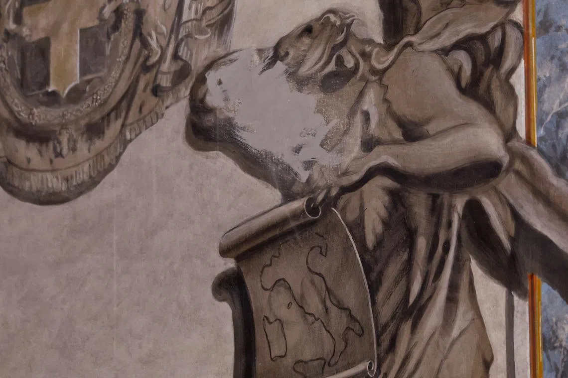 An apparent likeness of Italian Prime Minister Giorgia Meloni on an angel fresco painting is covered, after sparking political and clerical controversy, inside the Basilica of St. Lawrence in Lucina, Rome, Italy, February 4, 2026. REUTERS/Remo Casilli