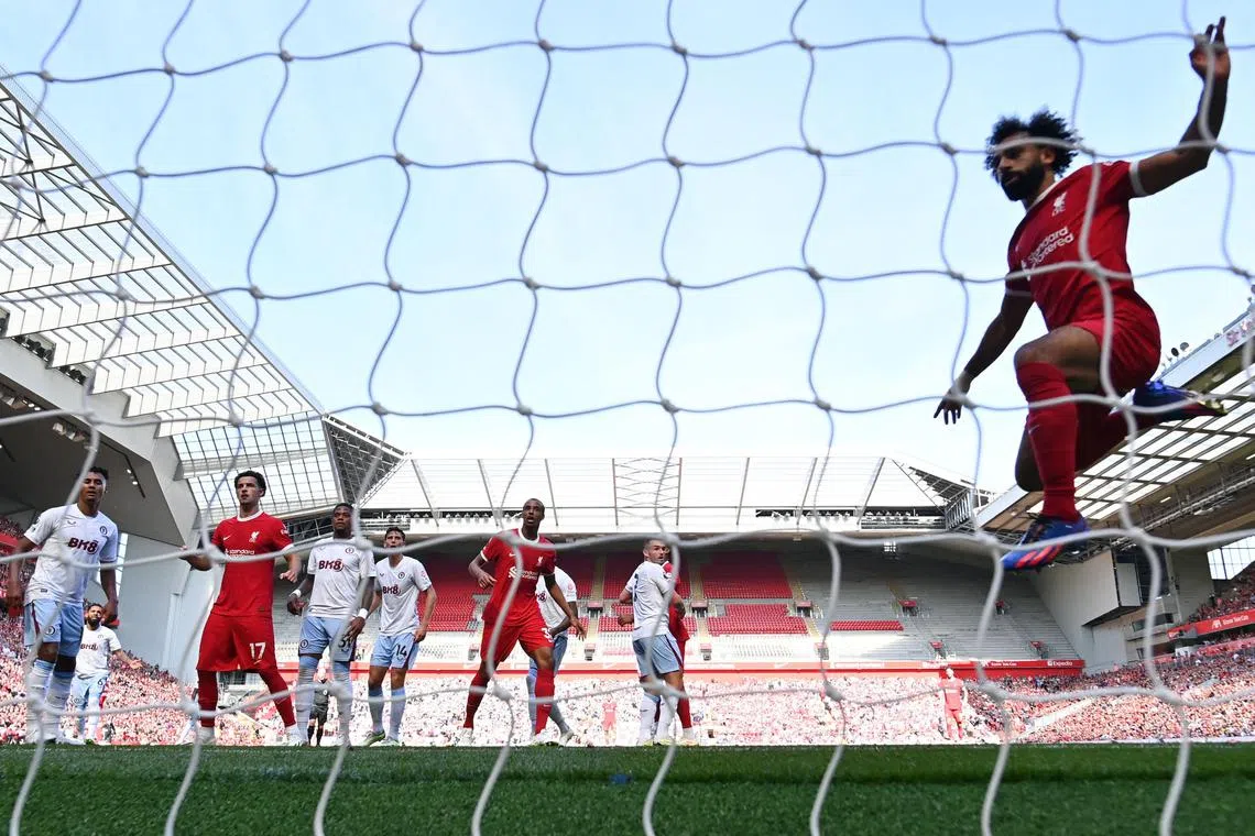 Liverpool striker Mohamed Salah celebrating after scoring his team's third goal against Aston Villa at Anfield.