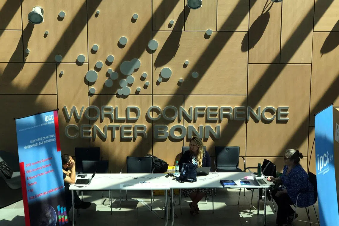 Visitors sit inside the World Conference Center Bonn during the Climate Change Conference in Bonn, western Germany on June 13, 2023. (Photo by ANDRE PAIN / AFP)