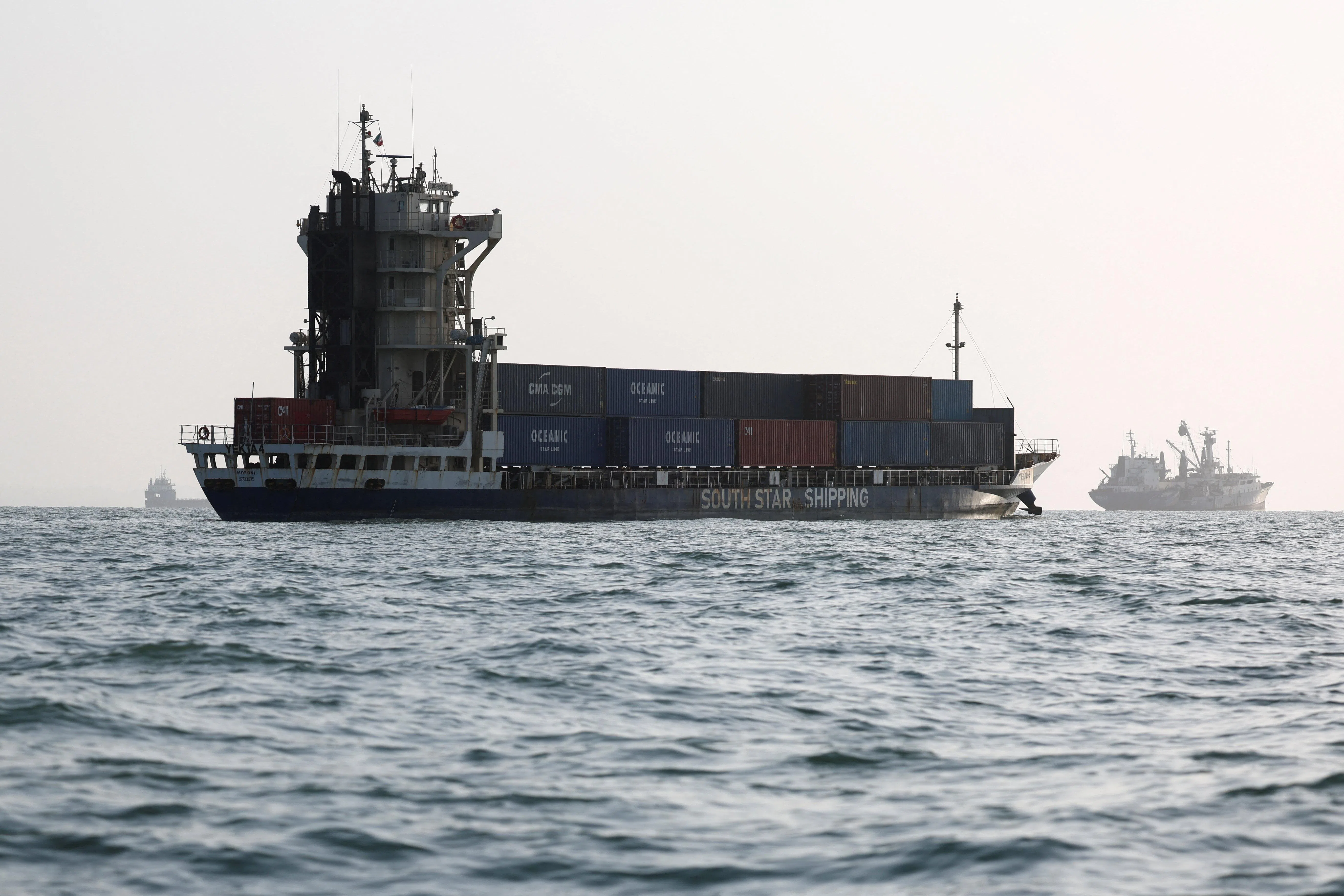 Vessels in the Strait of Hormuz are visible near the beach of Bandar Abbas, Iran, on Aug 27. The blockaded strait carries roughly a fifth of the world’s energy supplies.