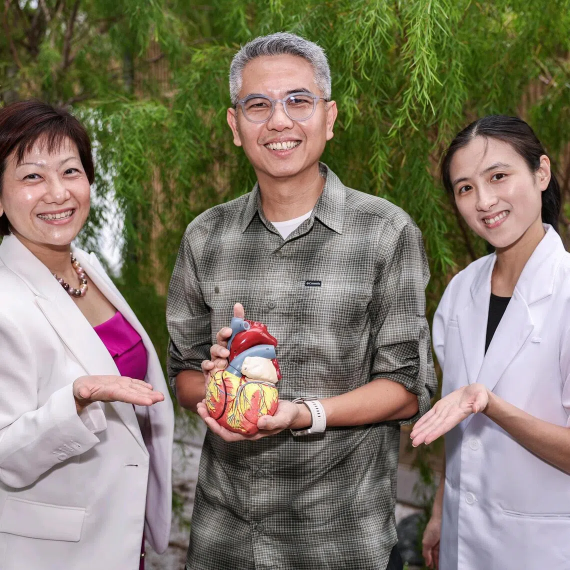 IT professional Gan Chee Hiong (centre) with cardiology specialist pharmacist Doreen Tan (left) and principal clinical pharmacist Elaine Lo.