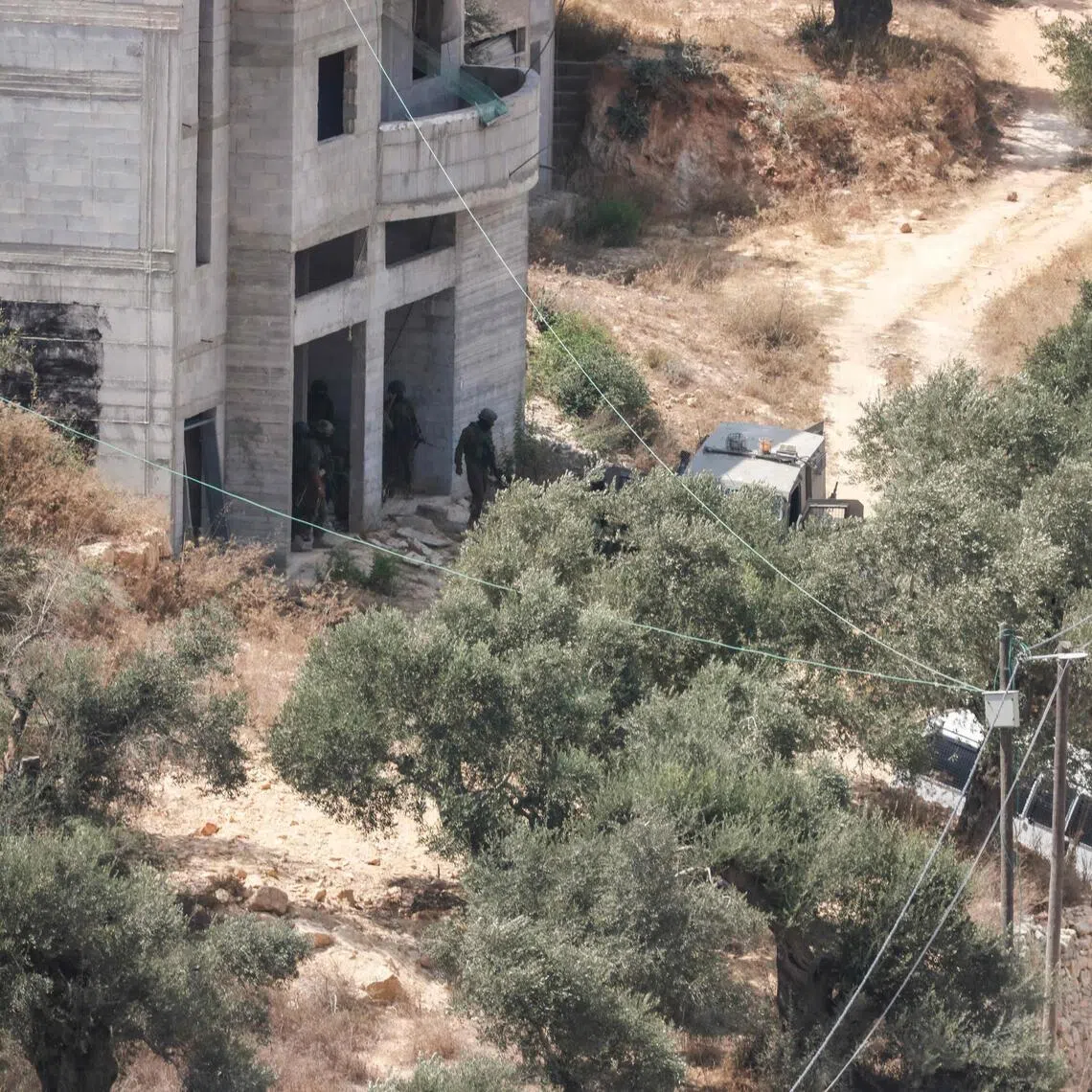 Israeli soldiers arrive at the scene where Israeli settlers attacked a Paletinian home in the village of Qusra, south of the city of Nablus in the Israeli-occupied West Bank, which has faced escalating Jewish settler violence over the past month, on August 29, 2026. Dozens of Israeli settlers attacked the Palestinian village of Qusra in the northern occupied West Bank on August 29, residents and the military said, after nearly three weeks of tension in the area. Earlier in August, a group of settlers began blocking supplies from entering Palestinian houses on the outskirts of the village near Nablus, trapping residents inside and drawing domestic and international condemnation. (Photo by Jaafar ASHTIYEH / AFP)