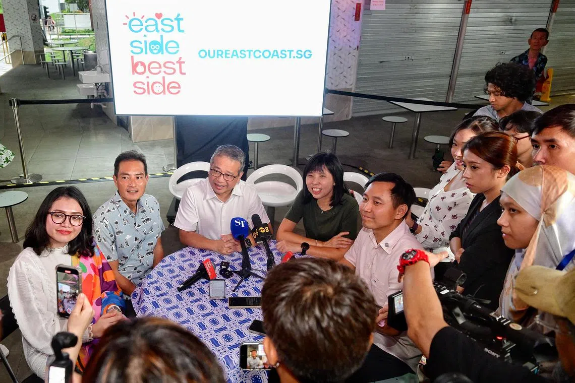 Culture, Community and Youth Minister Edwin Tong (seated, centre) with (seated, from left) PAP new face Hazlina Abdul Halim, Senior Minister of State for Digital Development and Information and National Development Tan Kiat How, Deputy Speaker of Parliament Jessica Tan and PAP new face Goh Pei Ming after an event at Bedok Food Centre and Market on April 15.