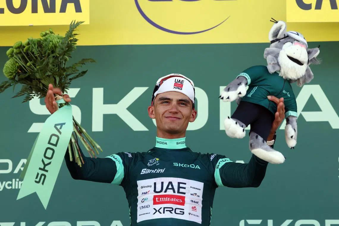 UAE Team Emirates XRG’s Isaac Del Toro celebrates on the podium wearing the green jersey after stage 2 of Tour de France on July 5.