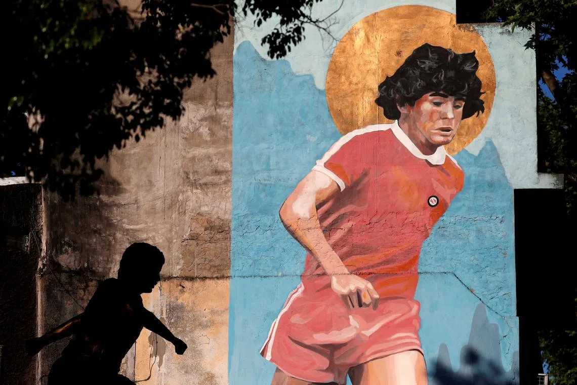 FILE PHOTO: A mural depicting late soccer legend Diego Armando Maradona is pictured outside the Diego Maradona stadium, before a celebration marking his 61st birth date, in Buenos Aires, Argentina October 30, 2021. REUTERS/Agustin Marcarian/File Photo