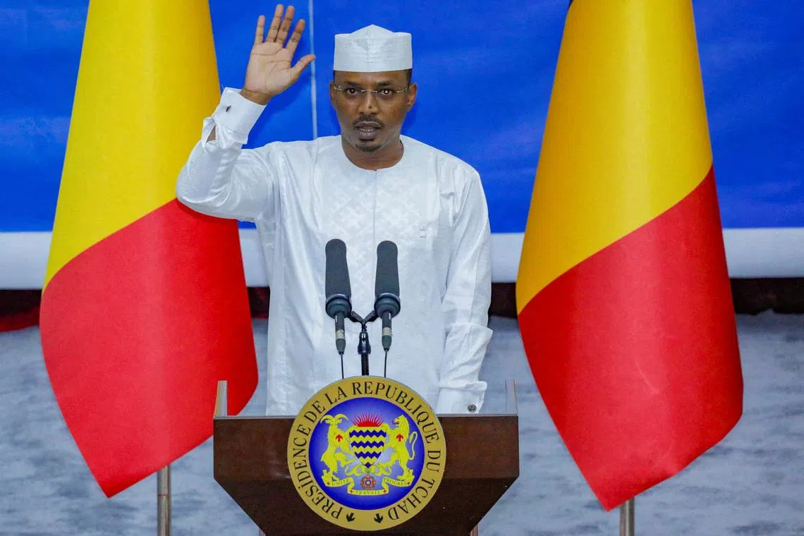 FILE PHOTO: Chad's newly elected President and junta leader Mahamat Idriss Deby raises his hand during his inauguration ceremony in N'djamena, Chad May 23, 2024. REUTERS/Israel Matene/File Photo