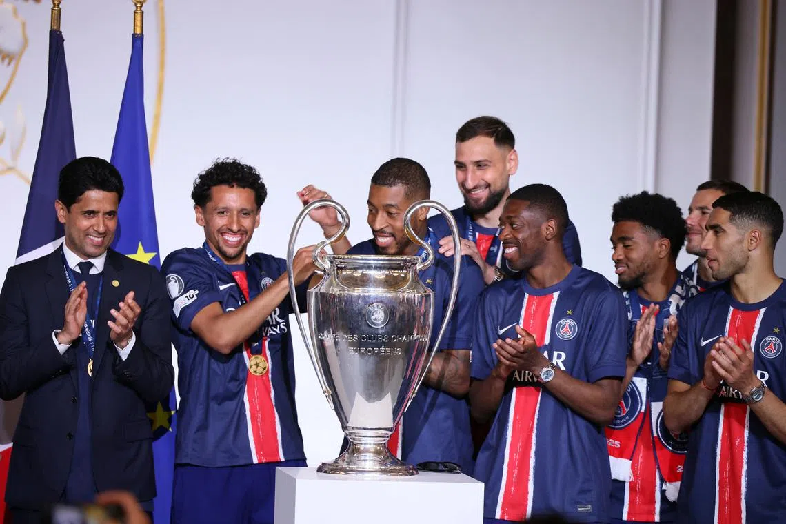 PSG president  Nasser Al-Khelaifi and players celebrate with the trophy after the team won the Champions League final soccer match between Paris Saint-Germain and Inter Milan, June 1, 2025 at the Elysee Palace in Paris, France. Thomas Padilla/Pool via REUTERS