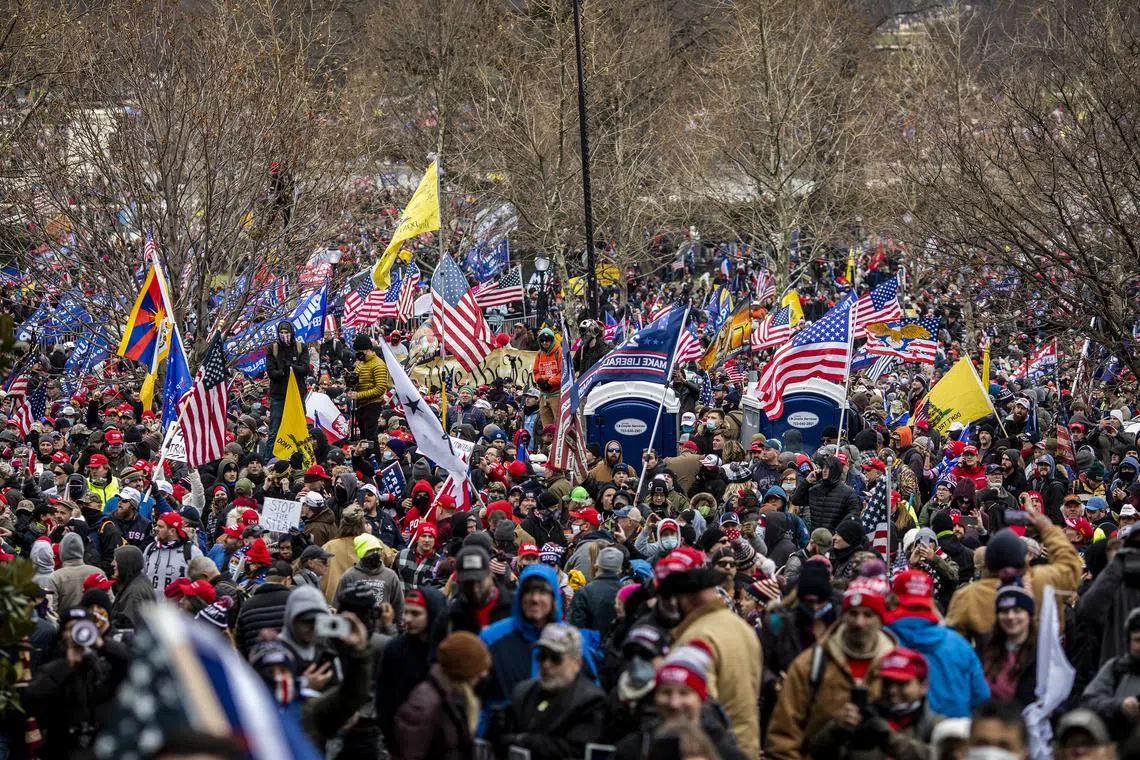 Protesters surround the U.S. Capitol after a rally at which then-President Donald Trump spoke, in Washington, on Jan 6, 2021.