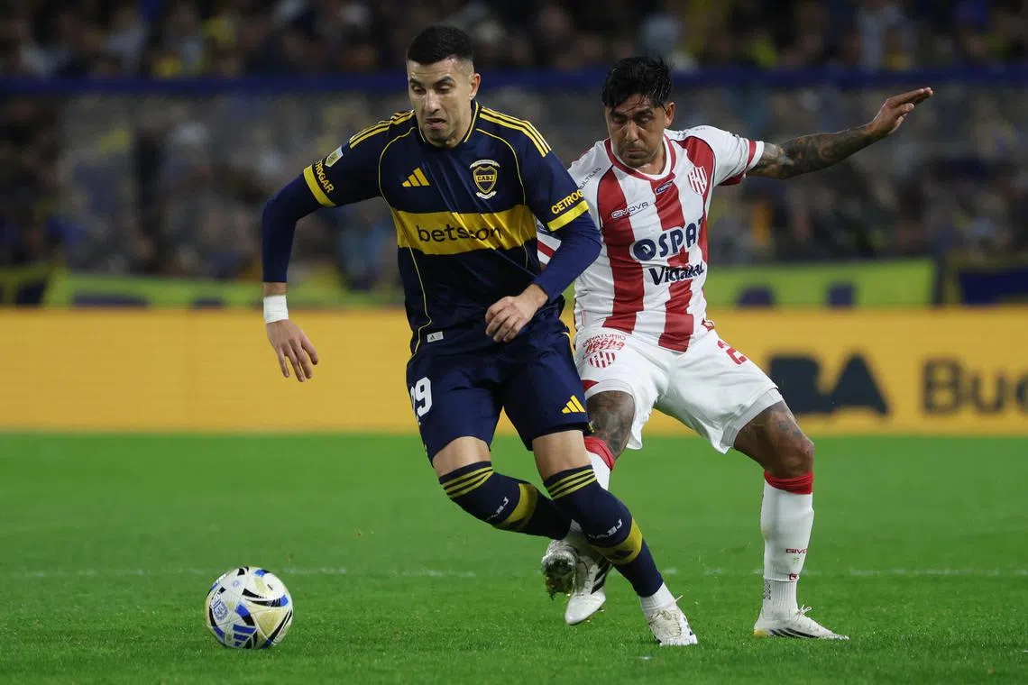 Boca Juniors' Rodrigo Battaglia (left) vies for the ball with Cristian Tarragona of Union in the Argentine First Division Clausura Tournament in Buenos Aires, Argentina on July 18, 2025.